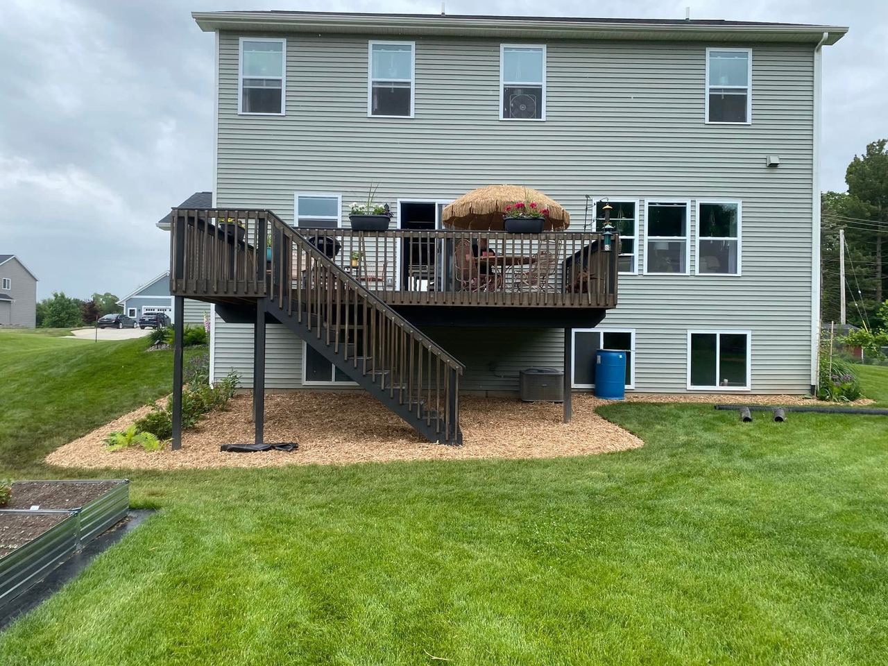 After — deck and foundation beds mulched and refreshed